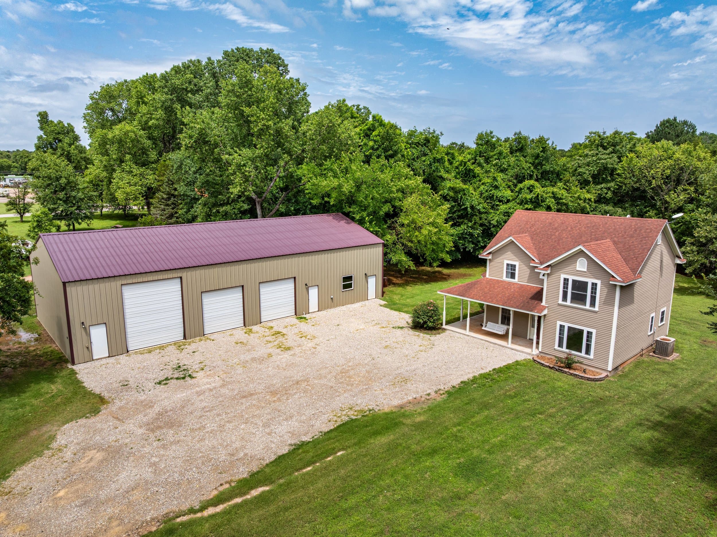 Aerial view of a rural Oklahoma property with a metal shop building and farmhouse
