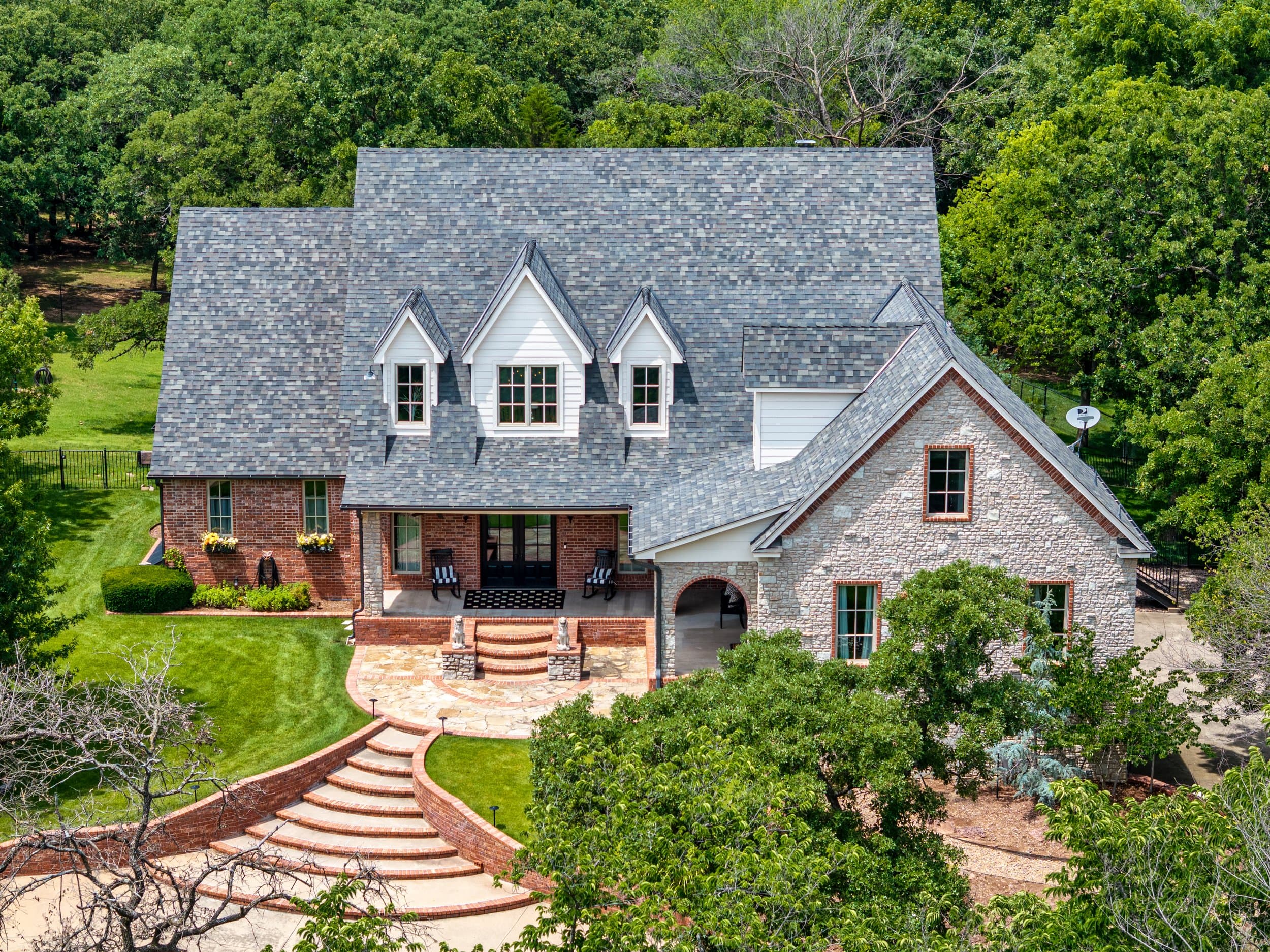 Aerial view of a brick and stone Oklahoma home photographed by Str8 Shooters