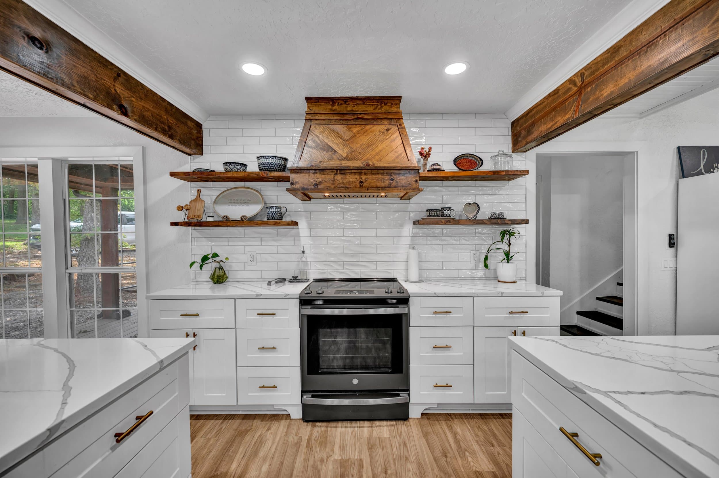 Renovated Norman kitchen with white cabinets, subway tile and reclaimed wood beams