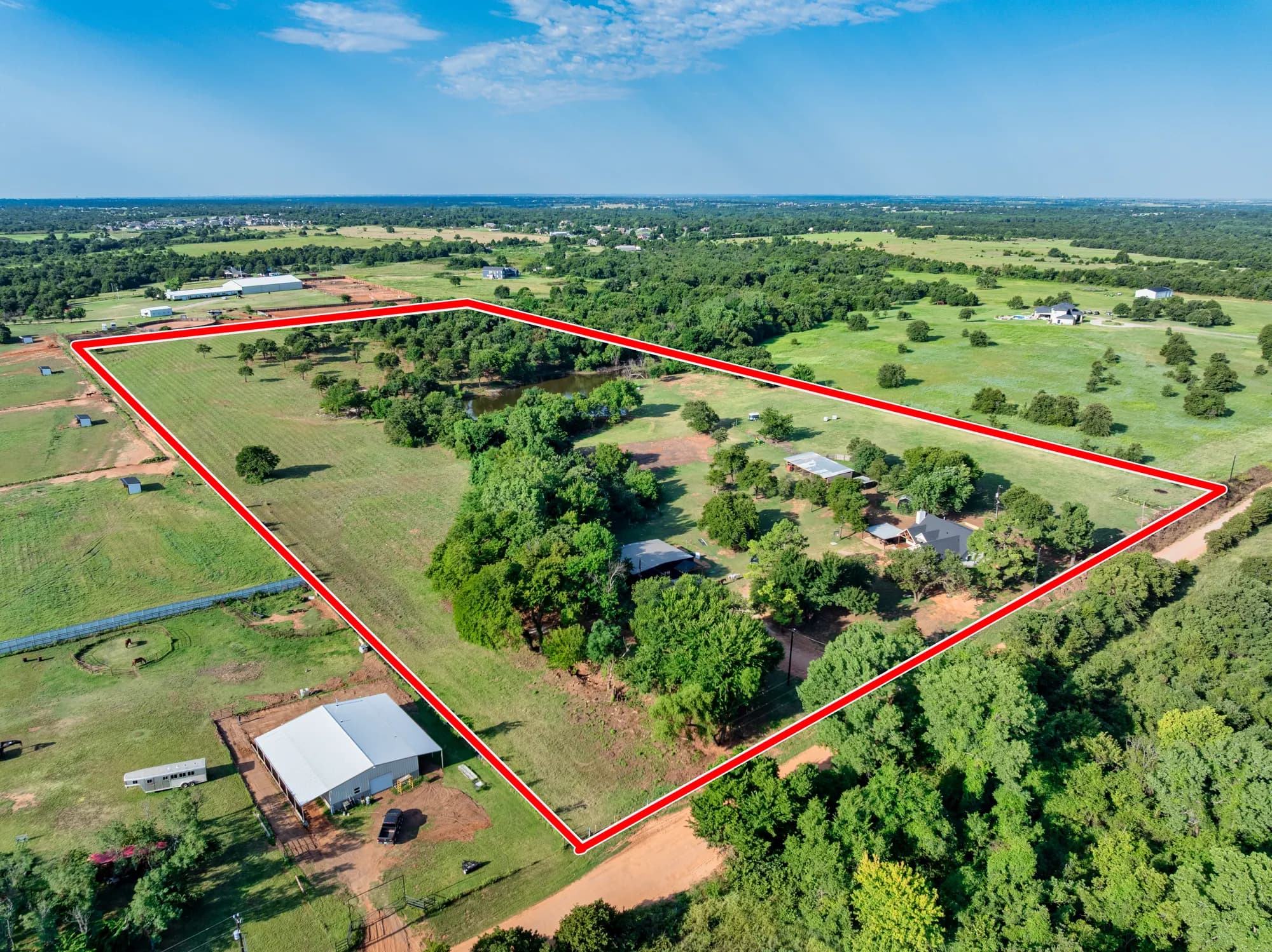 Aerial view of acreage with the parcel boundary outlined in red