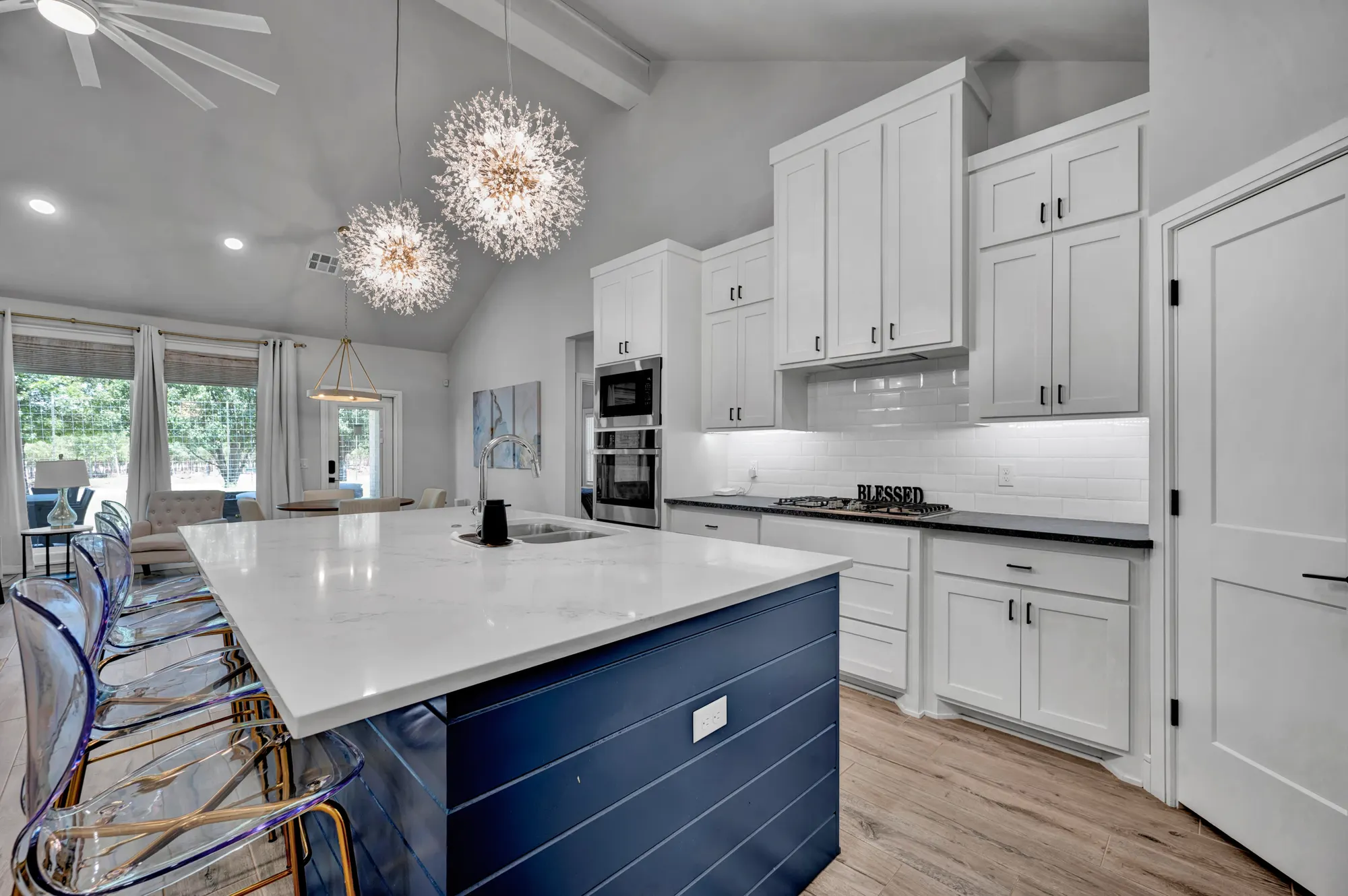 Edmond kitchen with a navy island, quartz counters and sputnik pendants