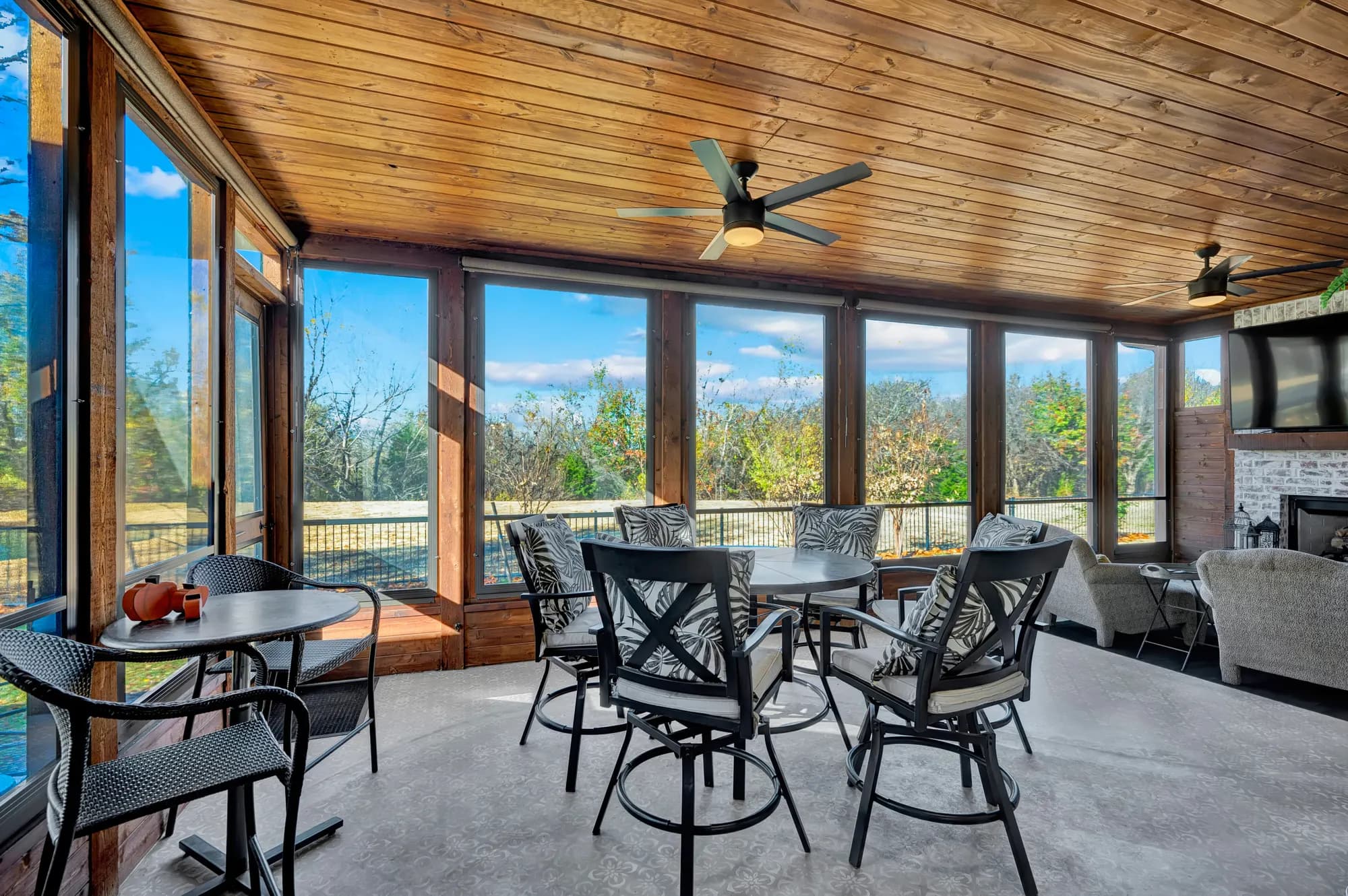 Screened porch with cafe seating overlooking open Oklahoma countryside