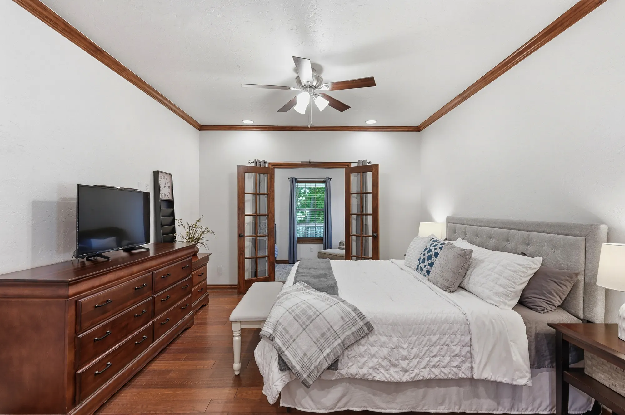 Bedroom with cherry furniture and French doors to the porch