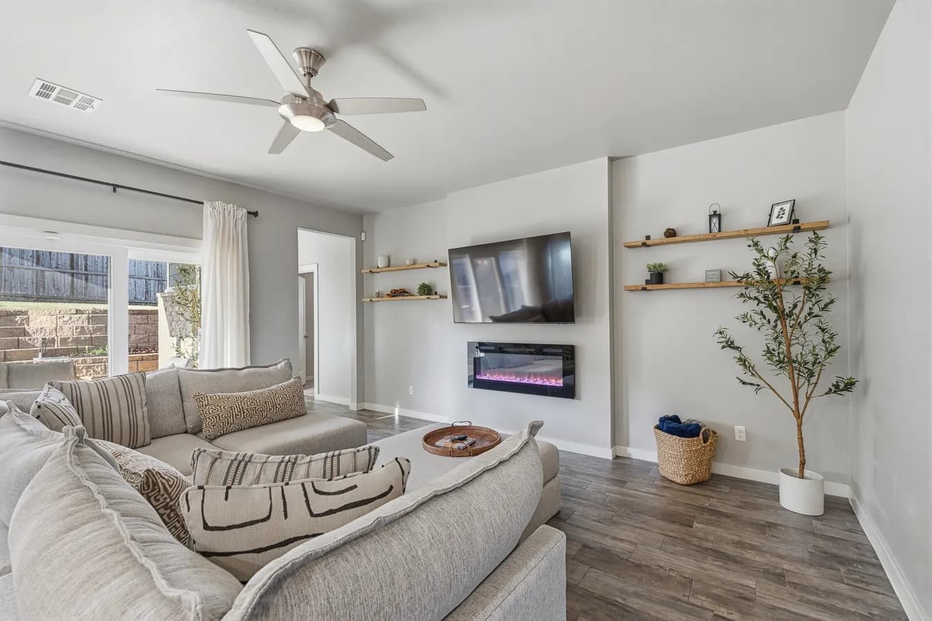 Edmond living room with a linear fireplace and floating oak shelves