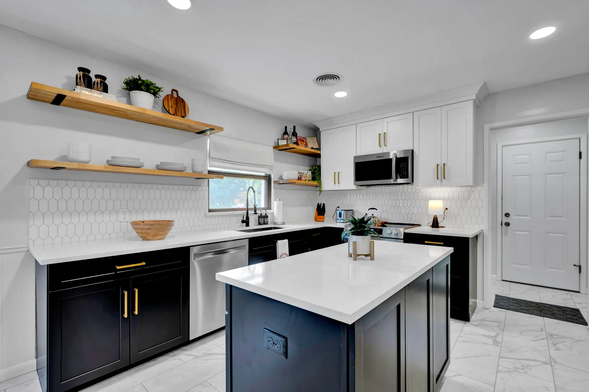 Norman short-term rental kitchen with a navy island and open shelving